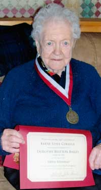 Dorothy Bailey '32, holding the certificate alums are awarded when they reach 100.