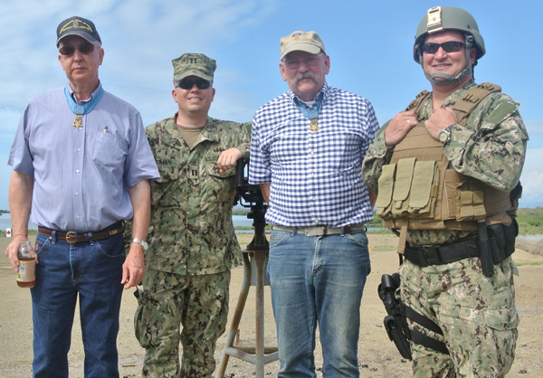 Lt. Josué Román ’98 (left) and Gunner’s Mate Chief Wayne Gibson ’96 (right) with two Medal of Honor recipients, Don J. Jenkins and Gary B. Beikrich (in civilian clothes), on a unit range training day at GTMO.